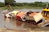 Trucks Fall Off Barge Into River
