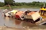 Trucks Fall Off Barge Into River