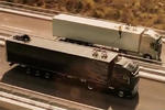 Woman Walks Slackline Between Moving Volvo Trucks
